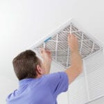 man doing duct cleaning changing filter